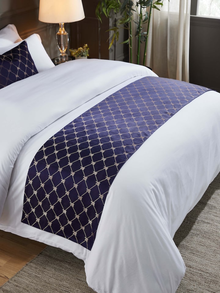 Styled bedroom setting with luxurious handloom silk runner on bed.