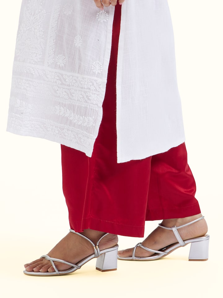 Angled view of red silk Banarasi palazzos emphasizing craftsmanship