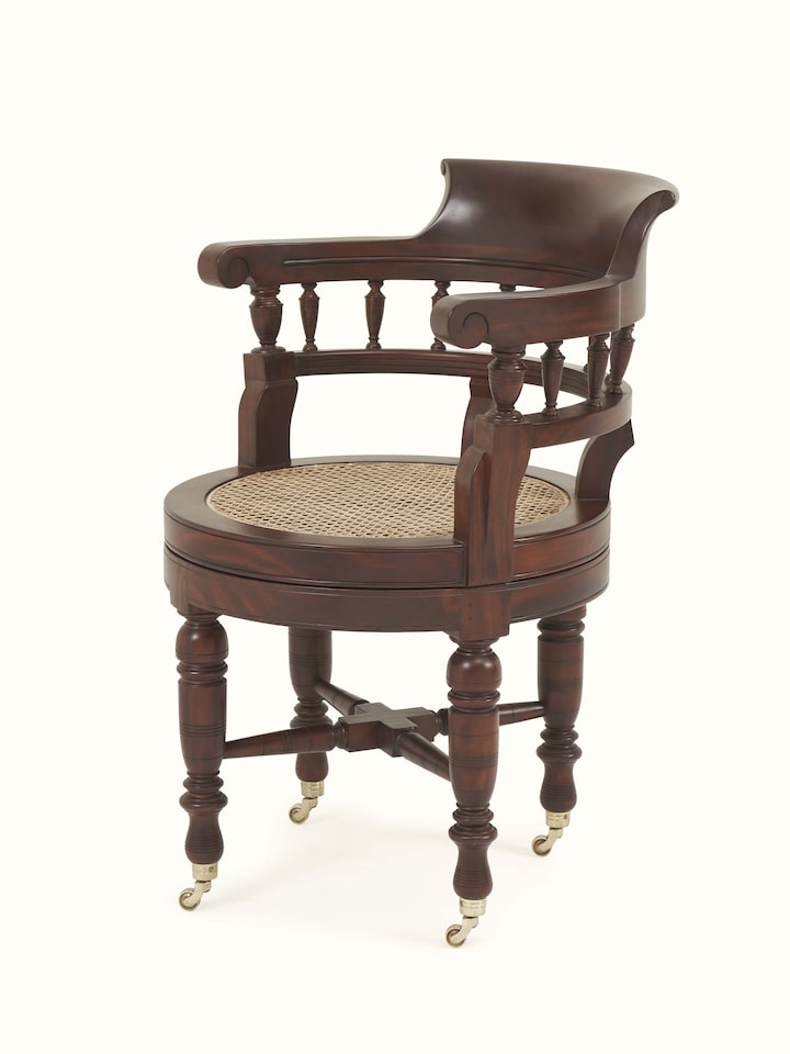 Angle view of Mahogany wood and cane study chair focusing on traditional cane seat and back
