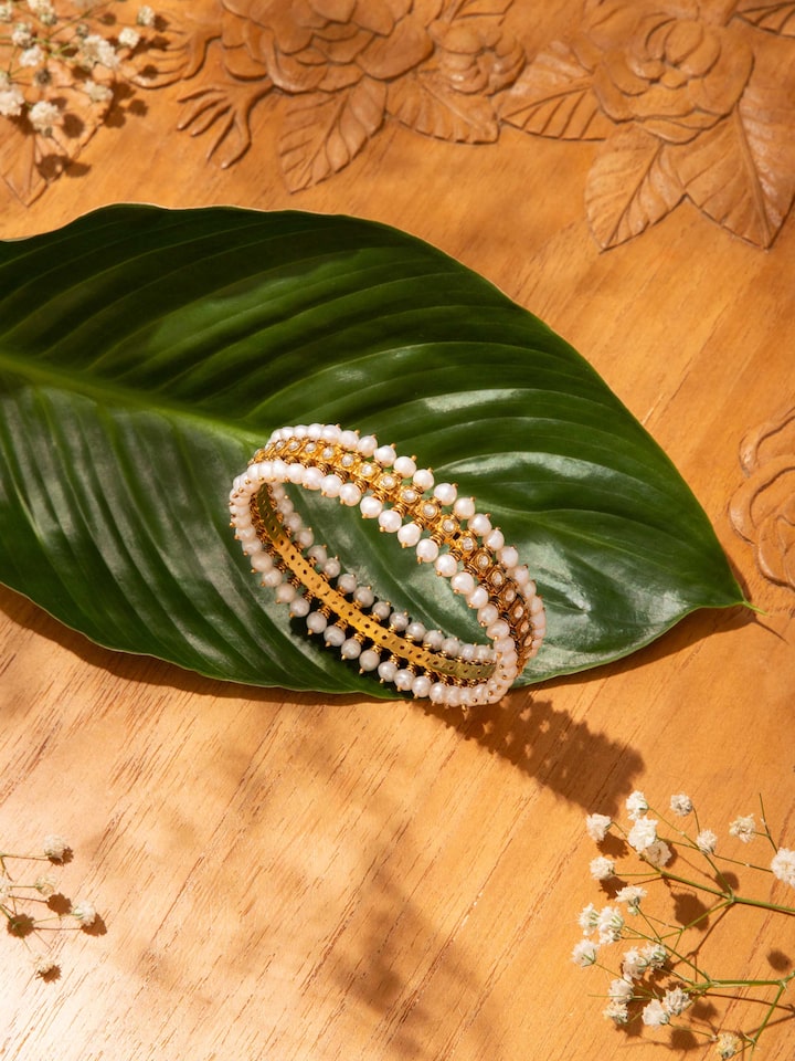 Lifestyle shot showing Guttapusalu silver bangle styled with ethnic ensemble.