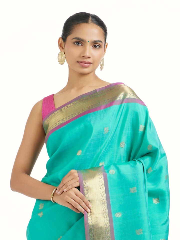 Angled view of blue silk Kancheepuram saree highlighting traditional weave and sheen