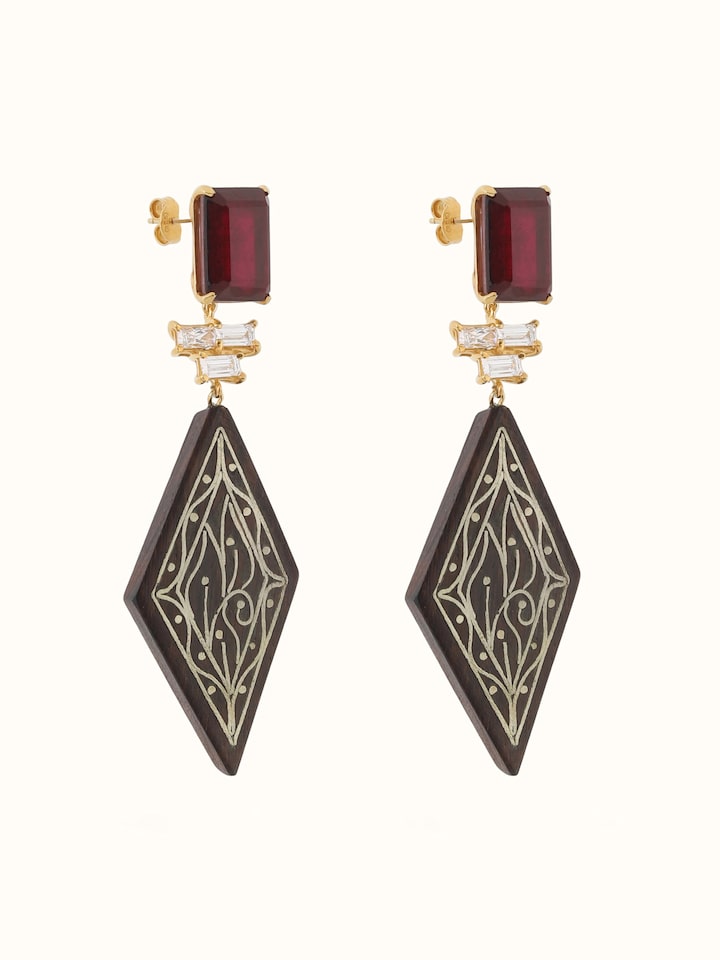 Angled view of Tarkashi silver drop earrings displaying intricate filigree craftsmanship