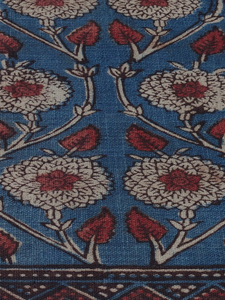 Detail view of indigo cotton Dabu hand block printed table runner highlighting the hand-blocked floral motif