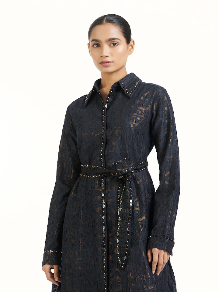 Angled view of black handloom cut work dress emphasizing handcrafted texture