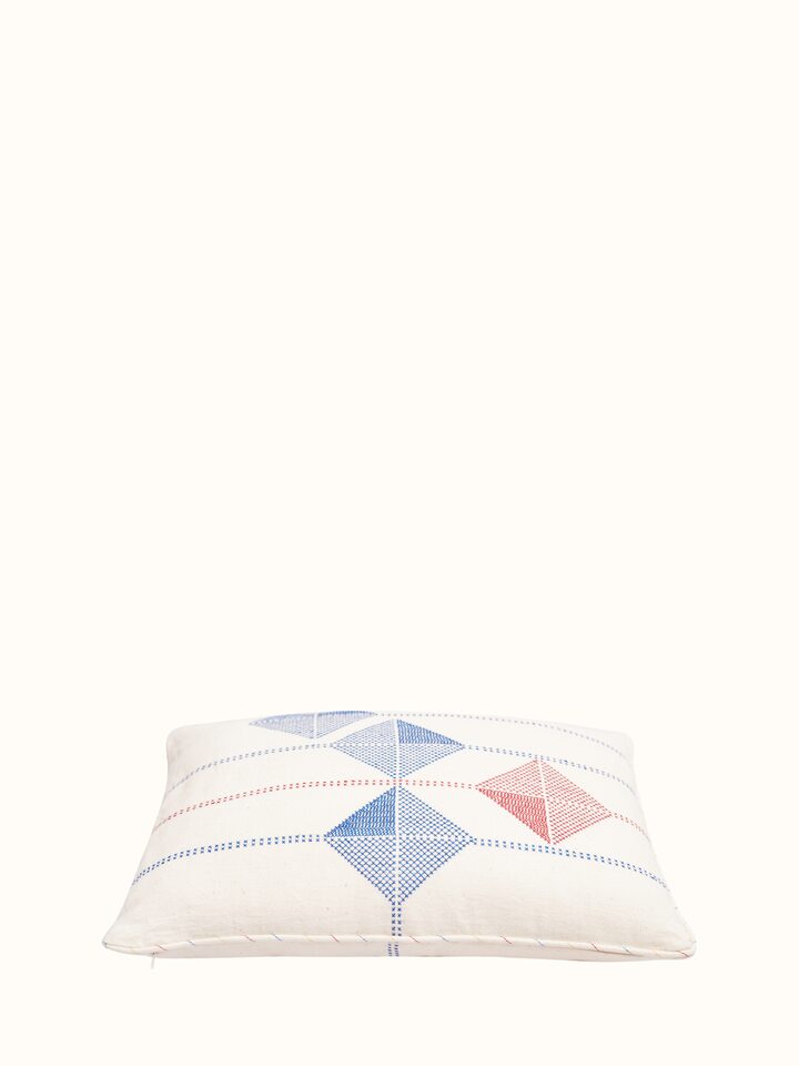 Angled view of Uttarayan Kutch Jat embroidered cotton cushion cover