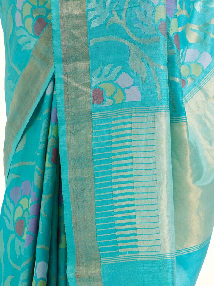 Detail view of turquoise mulberry silk Uppada Jamdani saree showing jamdani craftsmanship