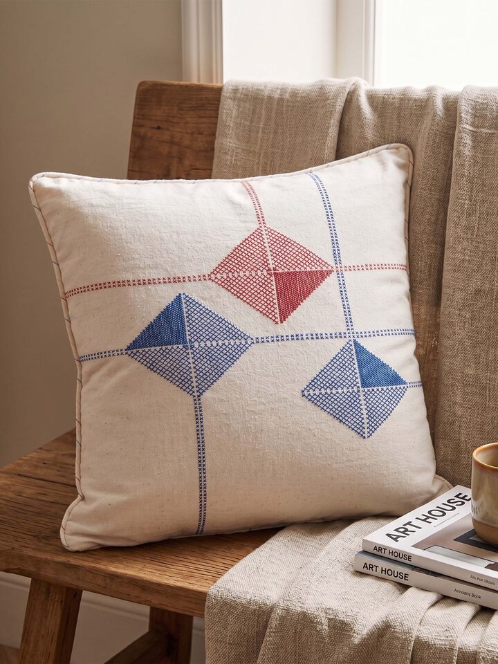 Lifestyle view of the Swadesh Uttarayan Hand Embroidery Kutch Jat Cotton Cushion Cover