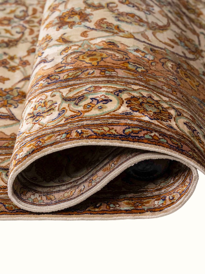 Detail view of Traditional Persian Ivory Rust Kashan Kashmir Silk Hand-Knotted Carpet highlighting the intricate pattern and pile texture, from a d...
