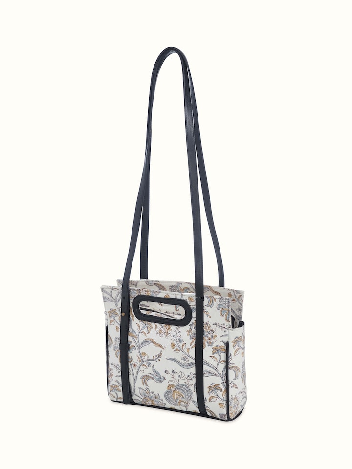Angled shot emphasizing hand block patterns and structured silhouette.