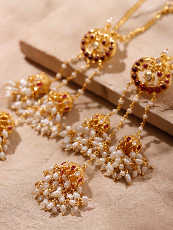 Detailed view of Guttapusalu silver drop earrings displaying intricate floral patterns and beadwork