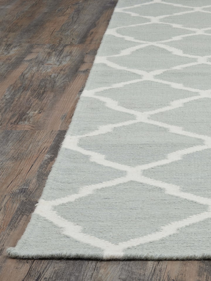 Angled close-up revealing the texture and intricate wool weave of the Panja dhurrie