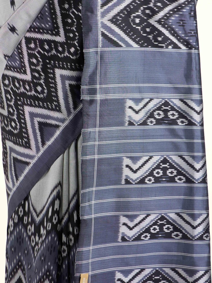 Detail view of off-white mulberry silk ikat saree showing craftsmanship