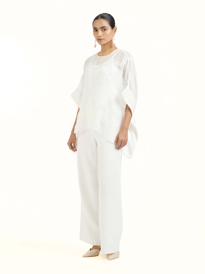 Side view of ivory hand embroidered organza kaftan highlighting airy drape and graceful flow