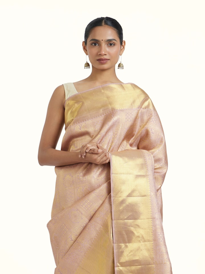 angled view of gold kancheepuram silk zari saree