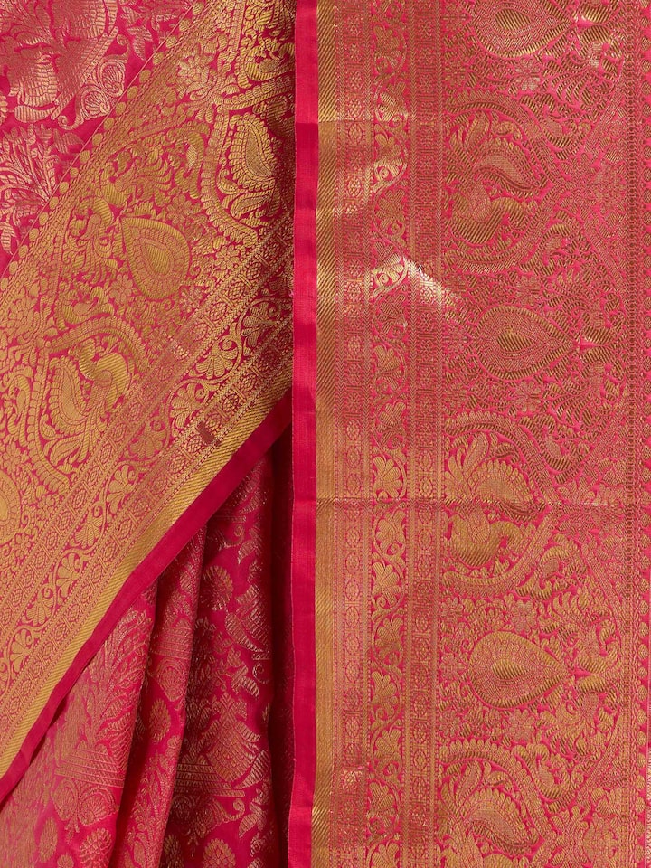 Detail view of red silk Kancheepuram saree showing silk texture and intricate zari work