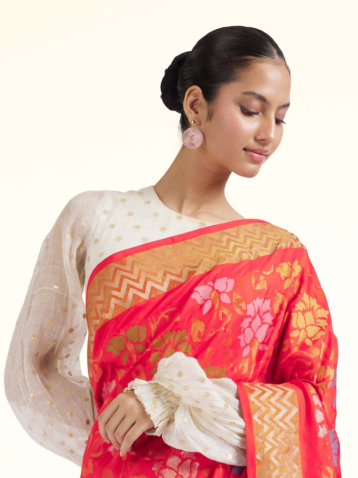 Angled view of red mulberry silk Uppada Jamdani saree emphasizing woven details