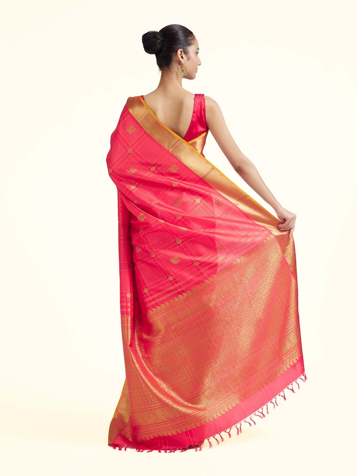 Back view of red silk Kancheepuram saree displaying ornate pallu design