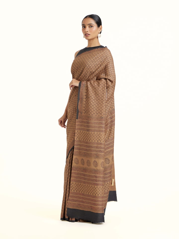 Side view of Beige Tussar Muga Silk Bagru Block Printed Saree highlighting the detailed craftsmanship and elegant silhouette