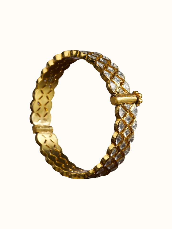 angled view of silver smithing gold plated bangle