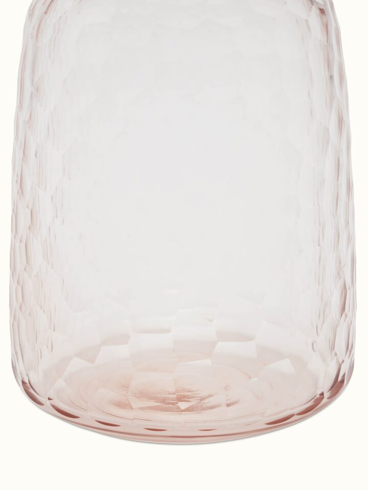 Artistic view of glass table vase in peach color, showcasing the overall design and color.
