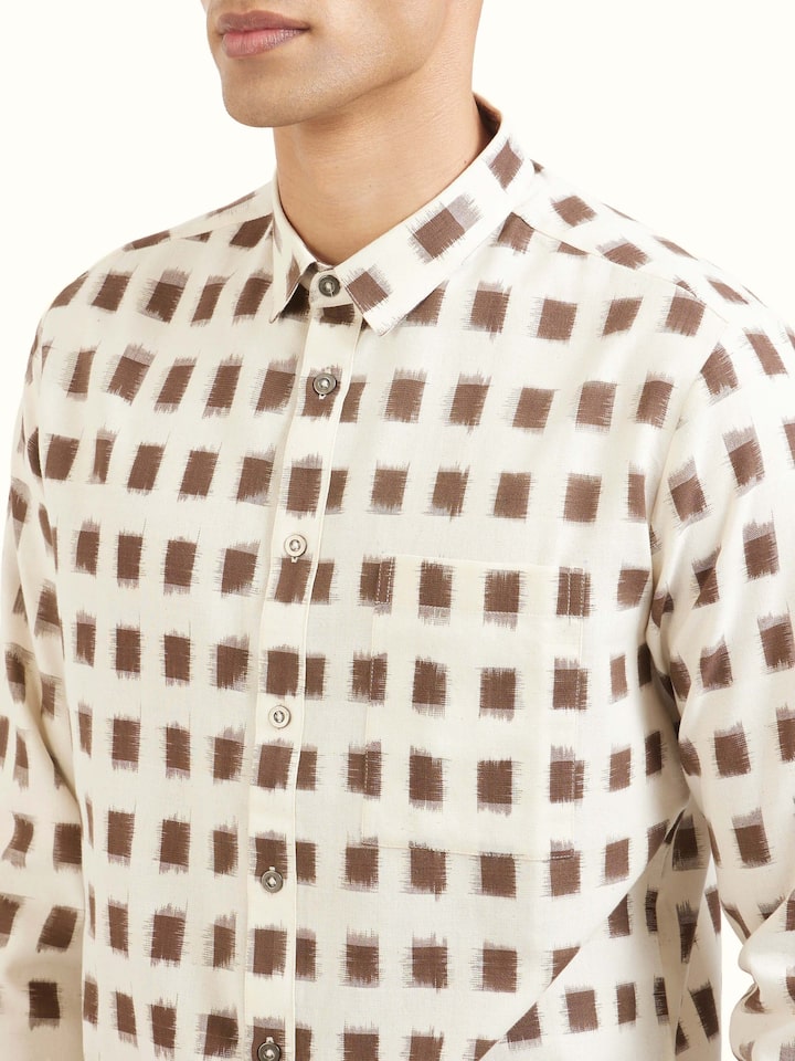 Detail view of white cotton Telangana Ikat shirt showing cotton texture and craftsmanship