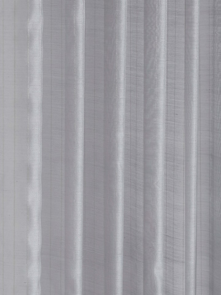 Close-up of textured weave and metallic stripes on grey Maheshwari handloom sheer curtain.