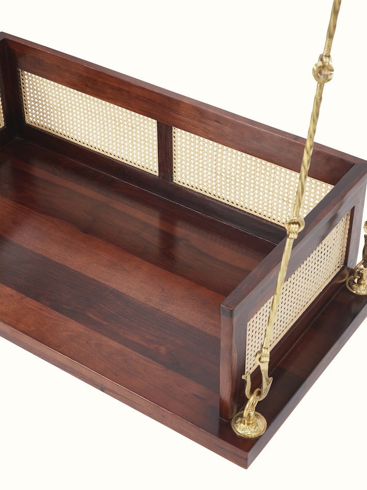 Close-up view of the Sheesham wood and cane swing’s detailed woodwork and cane design