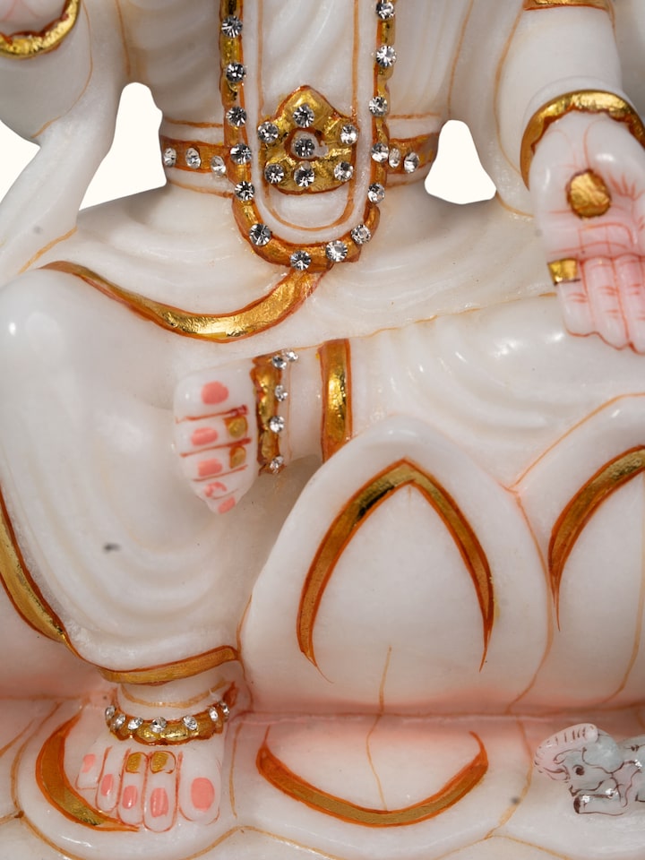 Detail shot of carved marble Lakshmi idol showing marble finish