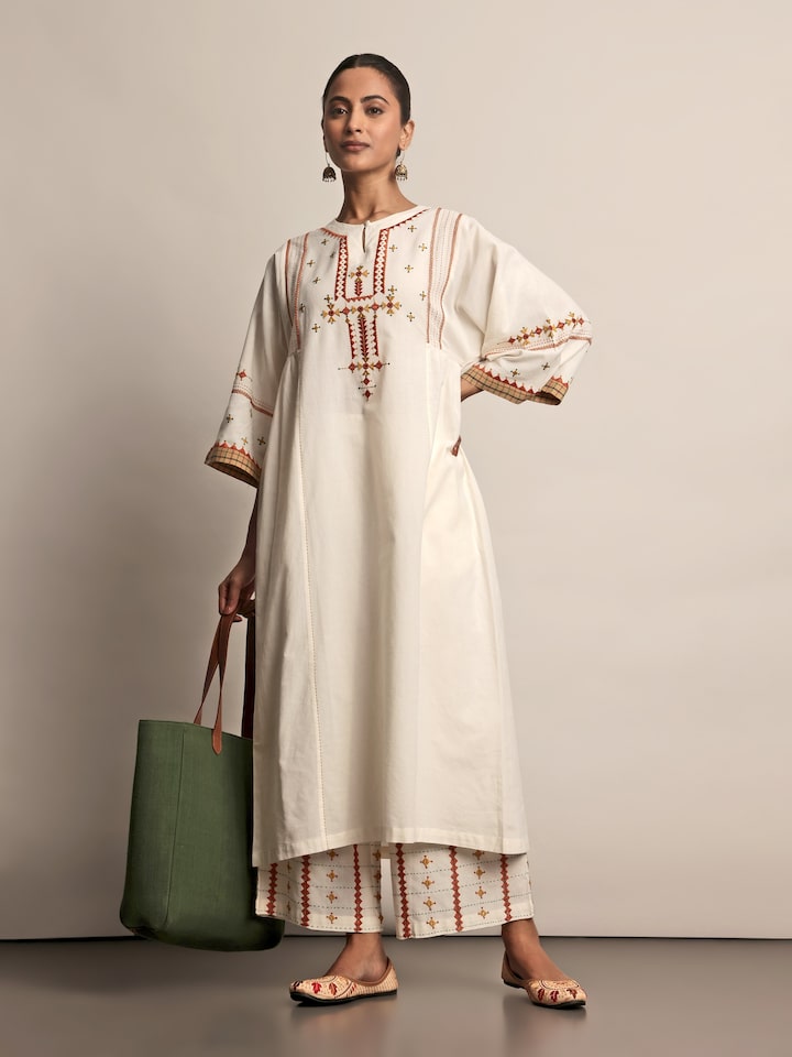 Angled view of Off-white Cotton Rajasthani Embroidered Palazzo showing fine embroidery and cotton fabric texture.