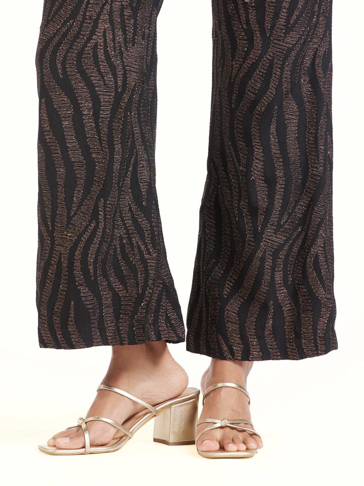 Detail view of black Aari hand embroidered pants showing threadwork