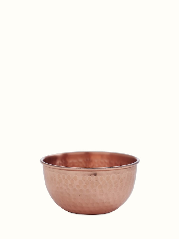 Front view of Copper Fruit Bowl displaying elegant design and shiny copper finish with smooth curves.