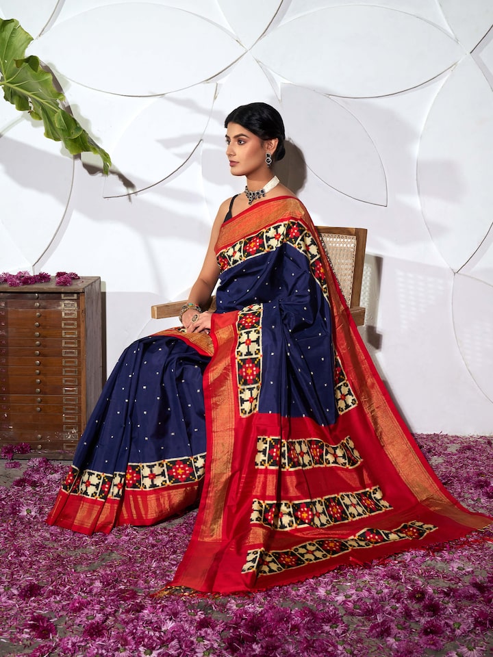 Angled view of blue silk Pochampally double ikat saree emphasizing double ikat weave