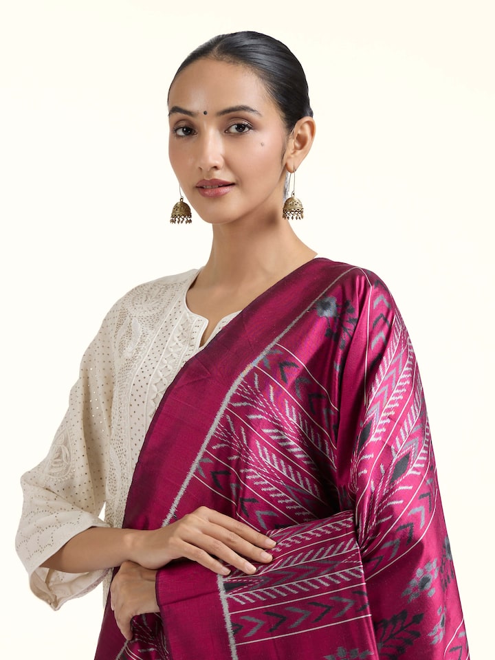 Angled view of pink silk Odisha ikat dupatta highlighting ikat patterns