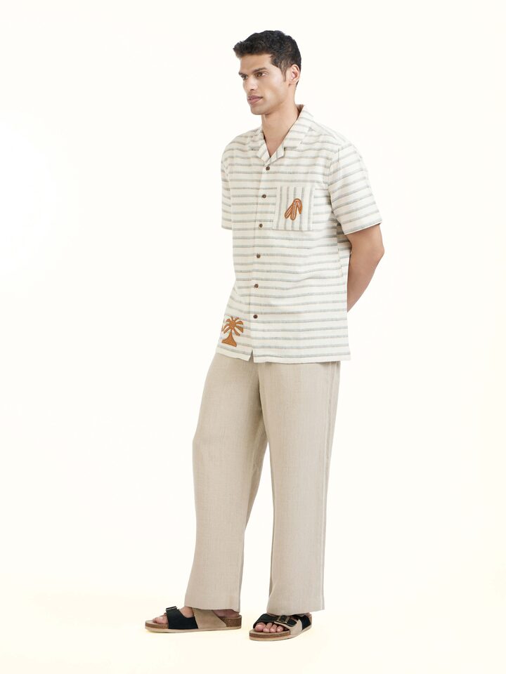 Side view of Ivory Kutchi Embroidered Shirt highlighting the detailed craftsmanship and elegant silhouette