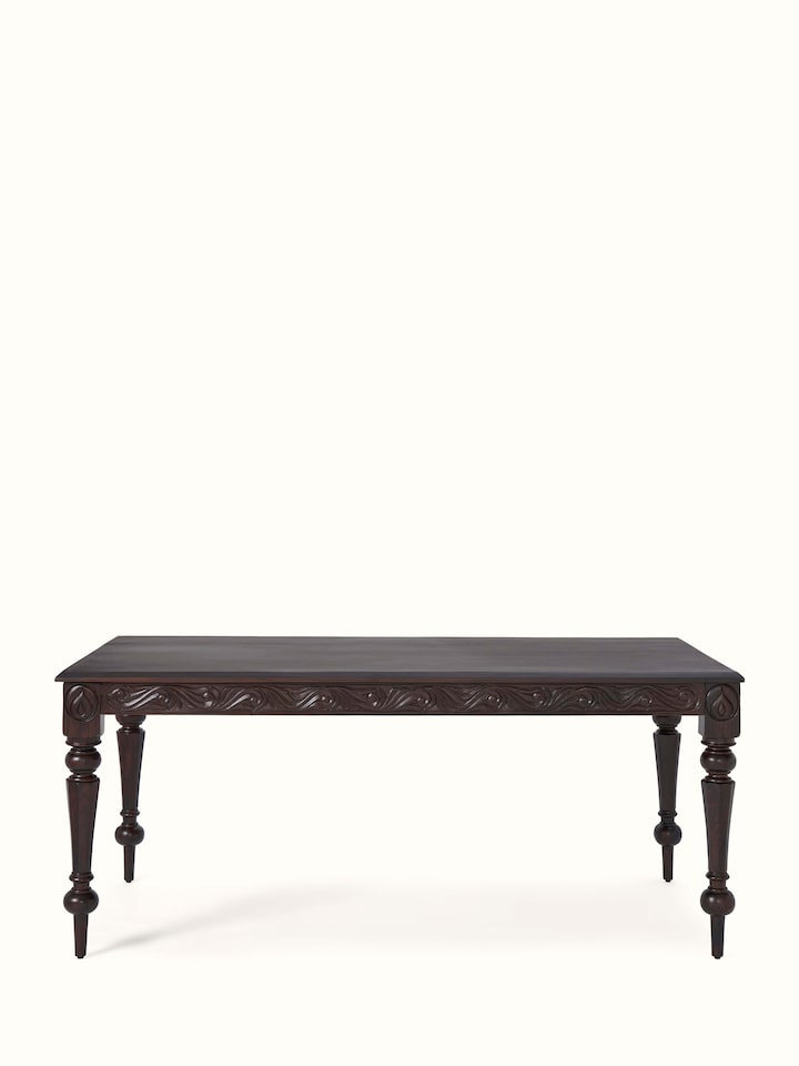 Front view of carved rosewood 6-seater dining table, highlighting its intricate carvings and rich finish