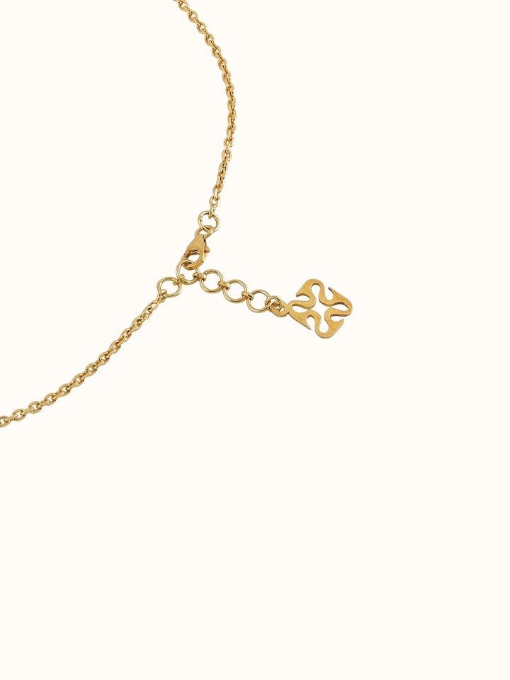 Detail shot showing close-up of pendant’s ornate floral pattern and silver finish