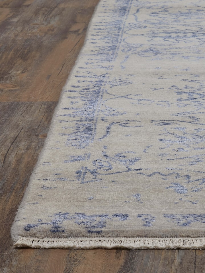 Angled view of Distressed Transitional Grey Blue Agra wool & viscose hand-knotted rug emphasizing the color variations