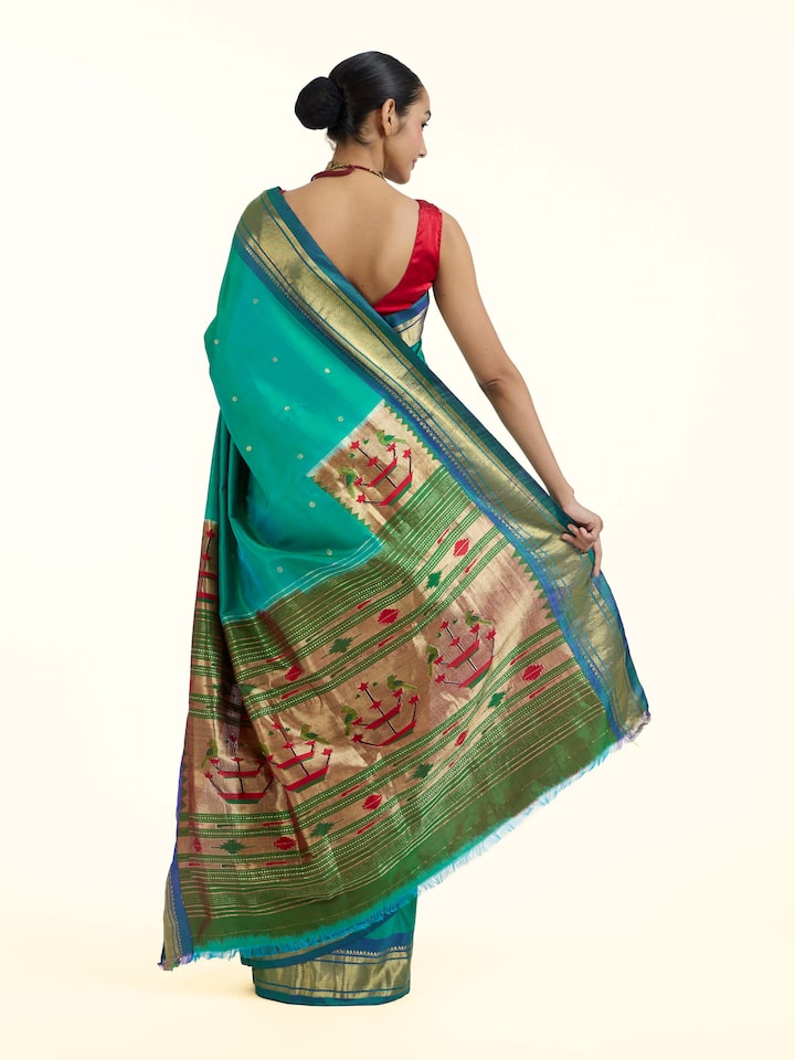 Back view of green silk Paithani saree displaying ornate pallu design