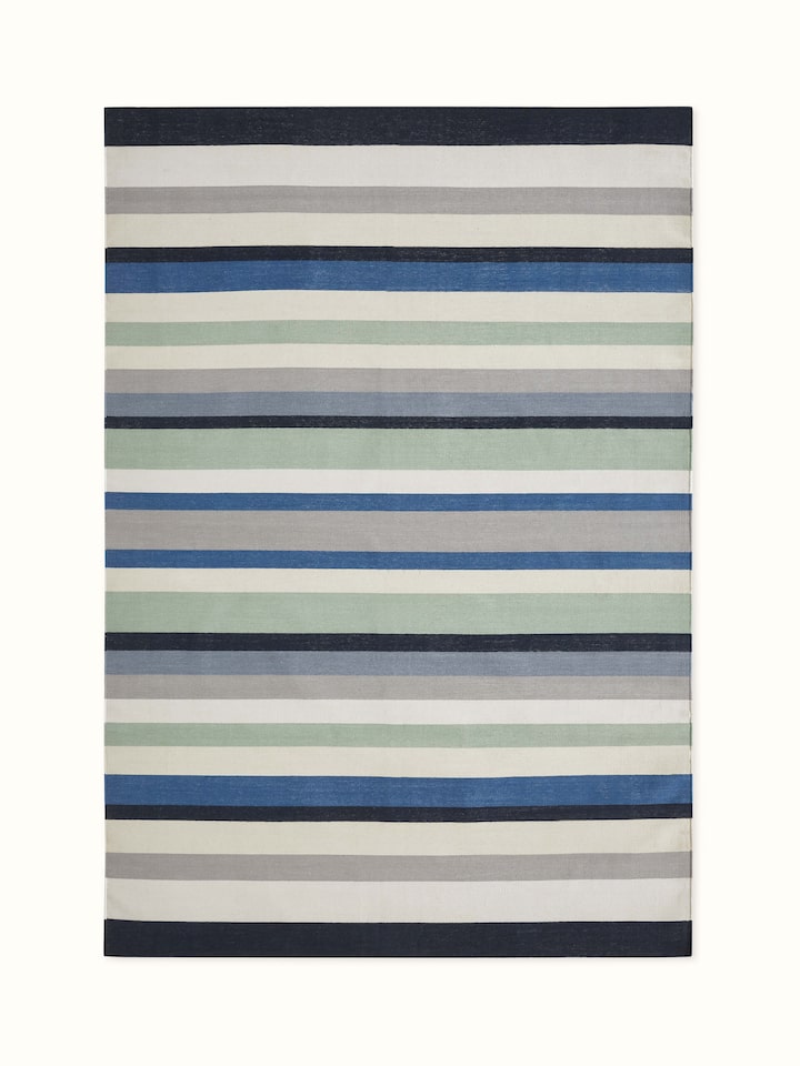 Front view showcasing the modern blue stripe pattern on the Lawan cotton dhurrie