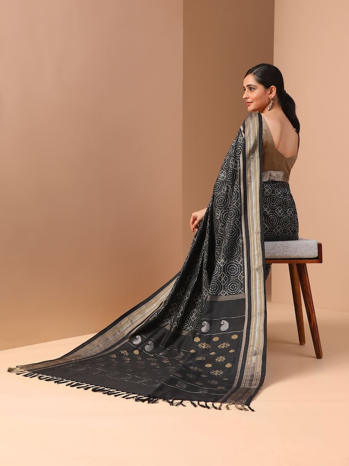 Lifestyle view of black double Ikat silk saree draped traditionally for an elegant ethnic look