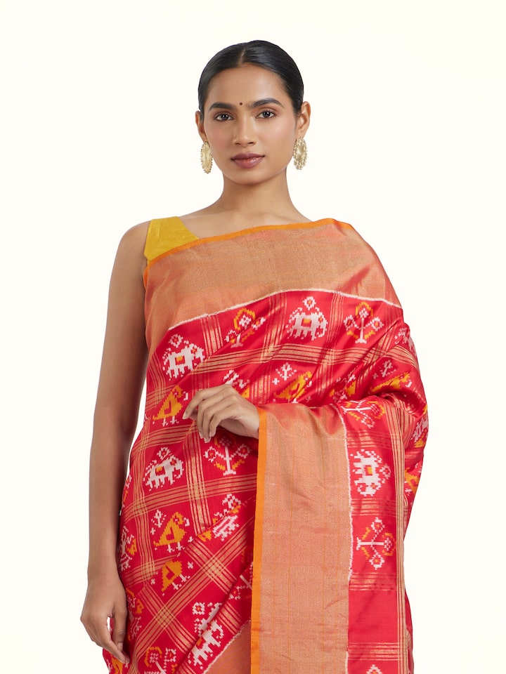Angled view of Red Pochampally Ikat Silk Saree revealing the depth of its color and intricate pattern