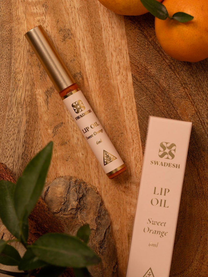 Close-up of Lip Oil Sweet Orange highlighting the applicator and rich, nourishing formula