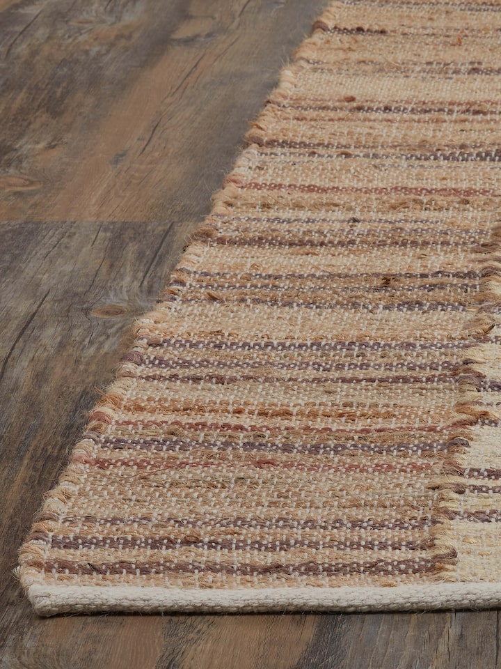 Angled view of Lawan Beige Brown Jute Rug highlighting the striped pattern and natural texture