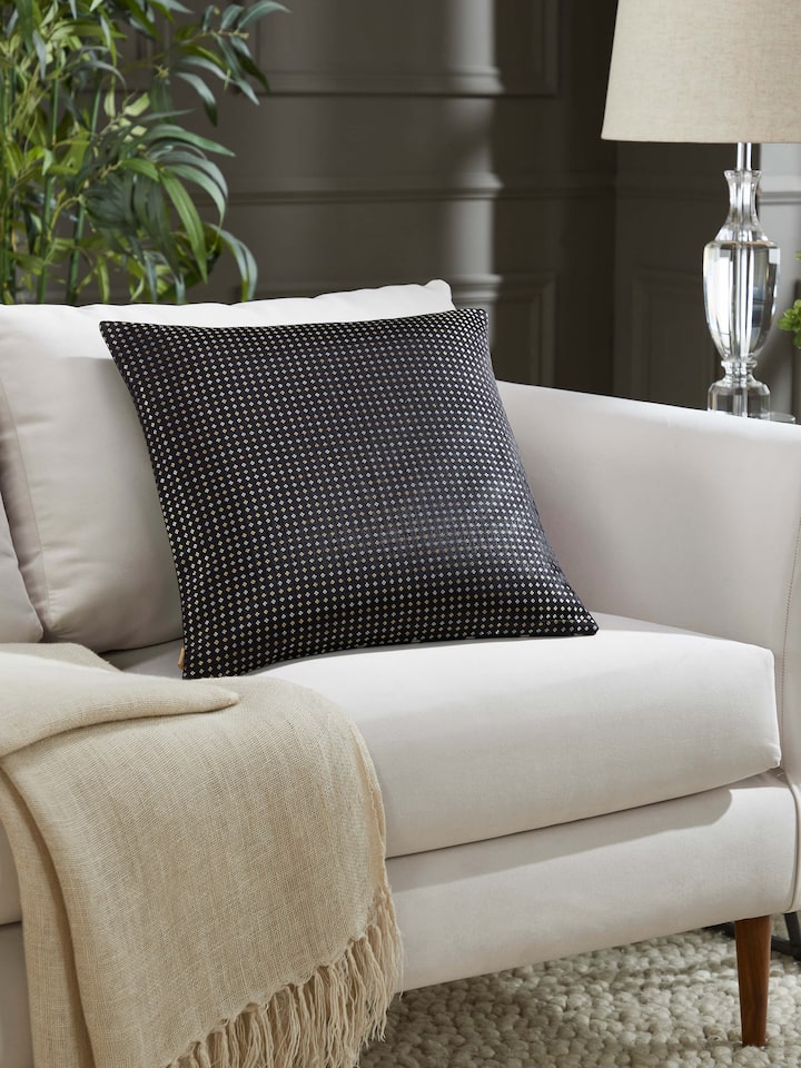 Awadh black striped Banarasi cushion cover styled in a living space for an elegant traditional look