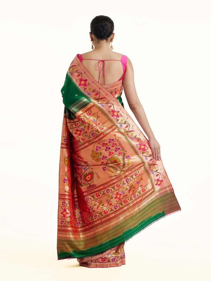 Back view of green silk Paithani saree displaying elaborate pallu design