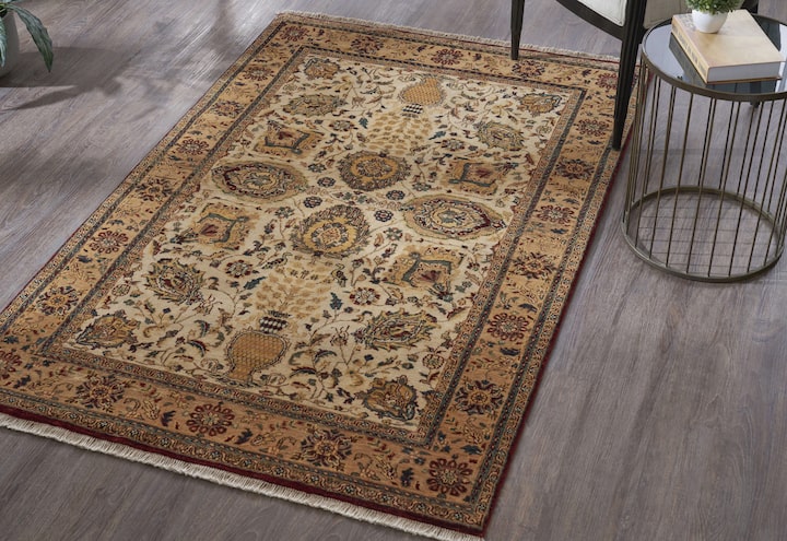 Gold Ziegler Jaipur wool hand-knotted rug styled in a warm traditional setting