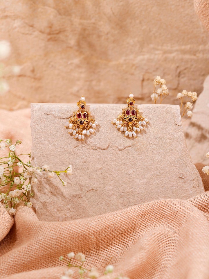 Styled detail view of Guttapusalu Silver Drop Earrings worn on the ear, shown in an alternate styled shot