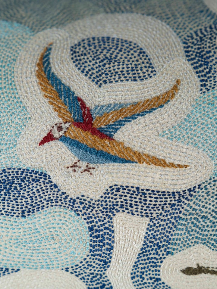 Side-angle view of the Bageecha Hand Embroidery Kantha Flying Bird Cushion Cover
