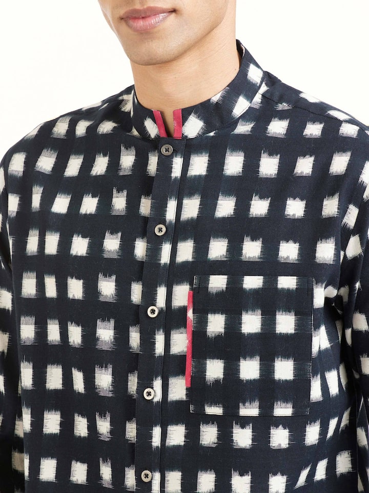 Detail view of black cotton Telangana Ikat shirt showing fabric texture and pattern clarity