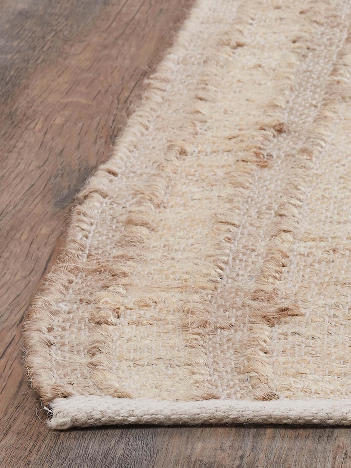 Detailed view of Contemporary geo beige jute & cotton natural fibre rug (5x8 ft) highlighting the natural fiber texture and design.